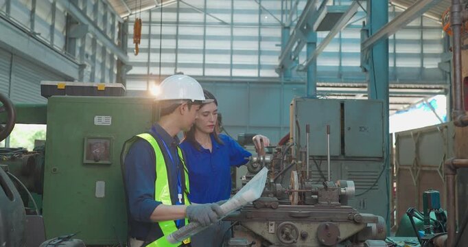 Engineer Reviews Technical Drawing With Startup Entrepreneur in Small Lab Workshop