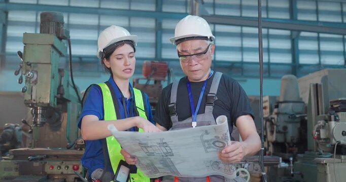 Father and Daughter Review Blueprint and Upgrade Plans in Family Factory Transition