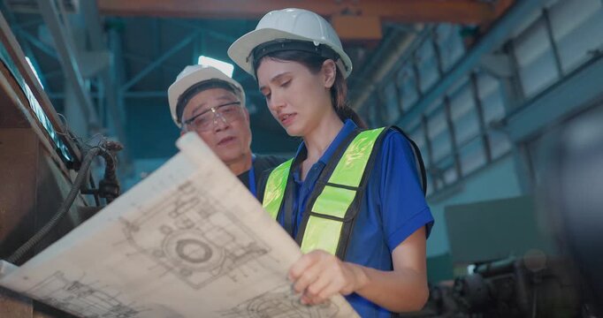 Father and Daughter Review Blueprint and Upgrade Plans in Family Factory Transition