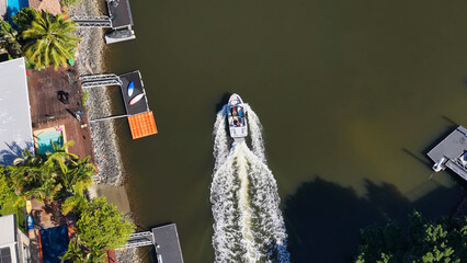 Aerial Top Down View of a Motorboat Navigating a Gold Coast Canal © blueringmedia