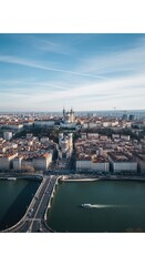 Obraz premium Blue sky and aerial panoramic view of a european city skyline with a river bridge and historic hillside basilica for travel marketing, urban tourism and architectural design