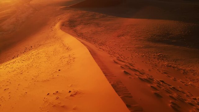 Drone footage captures the vast Namib Desert with towering red sand dunes glowing under the low setting sun, revealing breathtaking panoramic views of shifting patterns and timeless desert beauty.
