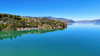 Fototapeta premium Aerial View of Akaroa Harbour with Coastal Houses and Calm Water