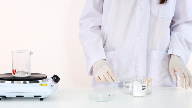 Scientist Preparing Sodium Acetate for Crystallization Experiment in Laboratory