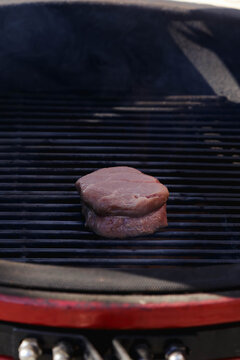 Thick beef fillet mignon steak searing on a hot grill grate