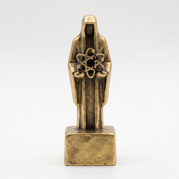 Bronze figure holding an atom. Science meets spirituality. A mystic icon.