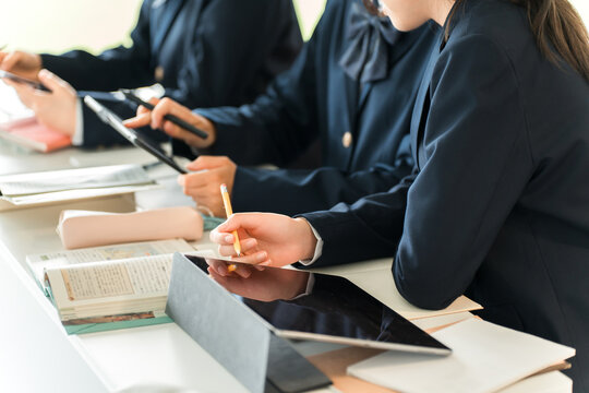 Elementary, middle, and high school students taking classes using digital devices such as tablets and personal computers (ICT education, e-learning)