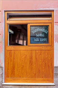 Monterosso, Spezia, Liguria, Italy - 30 Jule 2012: The wooden display window showcases Pasticceria Laura, a traditional Italian pastry shop in operation since 1966.