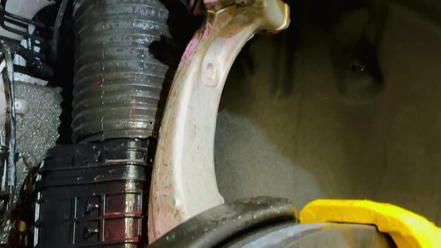 The process of washing the suspension, the underbody of the car with a chemical composition and a brush at the car wash. Washing the suspension of the car from reagents and contaminants using brush.  