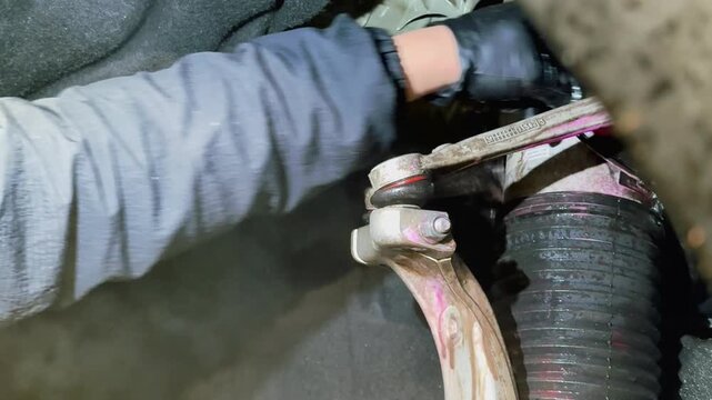 The process of washing the suspension, the underbody of the car with a chemical composition and a brush at the car wash. Washing the suspension of the car from reagents and contaminants using brush.  