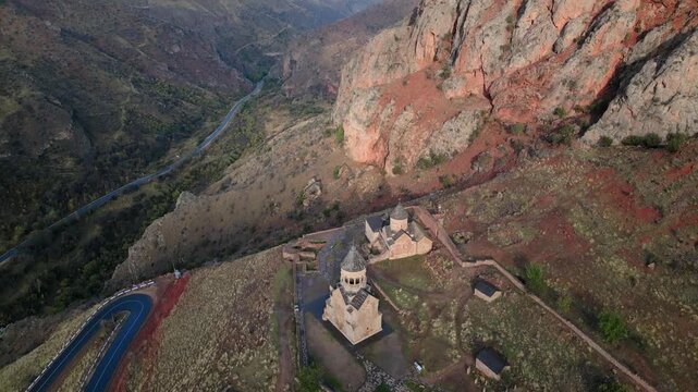 Flight over the ancient Noravank monastery in the mountains of Armenia. Fast motion fpv zoom out revealing view
