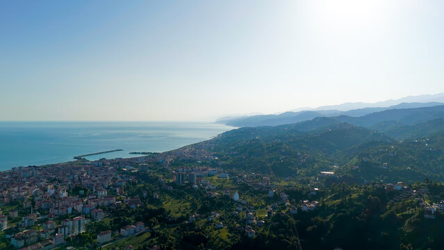 Ardeshen, Turkey. Aerial panorama over the Firtina River Valley, where dense green hills roll toward the Black Sea coast under bright morning light