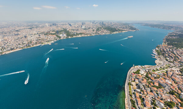 Istanbul, Turkey. Heavy maritime traffic in Bosphorus strait between Uskudar Ferry Terminal and Kabatas Ferry Docks Ferries and ships crossing between Europe and Asia at summer midday. Aerial view