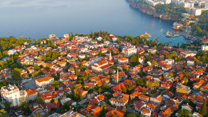 Naklejka premium Antalya, Turkey. Aerial drone view featuring Kaleici Old Town, yacht marina, Mediterranean Sea and dramatic rocky coastline in morning light.. Aerial View