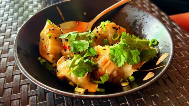 Spicy Asian dumplings in a black bowl served at Catangnan Philippines