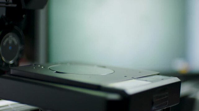 Closeup of a laboratory instrument stage in focus, equipment in a science setting