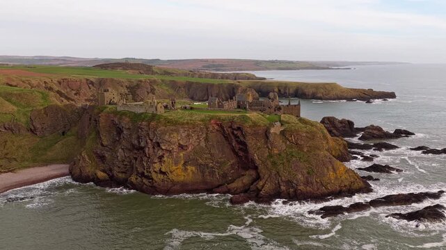 Majestic dunnottar castle ruins standing on a dramatic rocky headland overlooking the north sea in aberdeenshire, scotland
