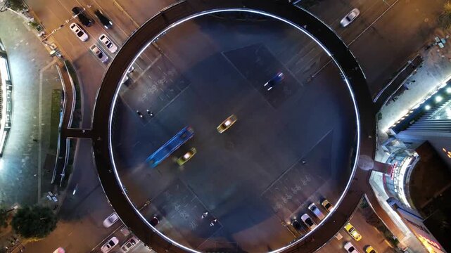 Shanghai Lujiazui illuminated circular pedestrian bridge and night traffic