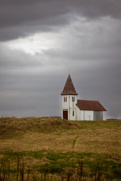 Rural church standing alone on a hill in Iceland