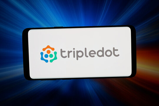 Stuttgart, Germany - 04-27-2026: In this photo illustration, the logo of video games company Tripledot Studios Limited is displayed on a smartphone in front of abstract background on computer screen.
