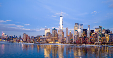 Fototapeta premium New York City skyline at night. NYC Manhattan panorama. New York skyscrapers reflections. Downtown Manhattan skyline.