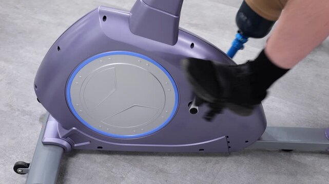 Disabled man with prosthetic leg pedaling stationary exercise bike