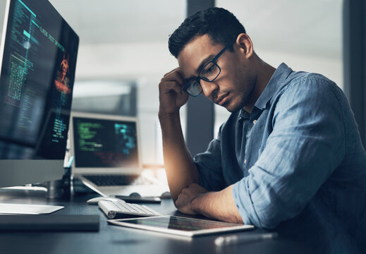 Frustrated, man and cyber attack with computer for virus, theft or cybersecurity breach in office. Male person, upset or programmer with tablet for software error, mistake or malware in workplace