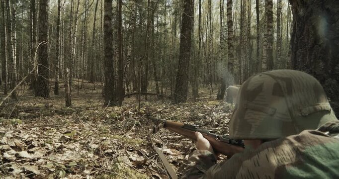 Reenactor Dressed As German Infantry Soldier Shoots From Rifle Carabine Mauser 98k In