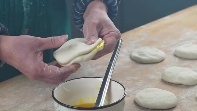 Hands skillfully preparing dough with egg filling for baking delicious pastries