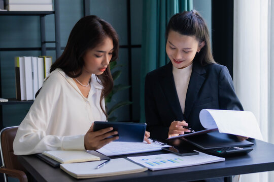 Asian boss businesswoman working with intern together in office room