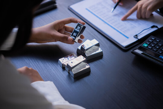Two Asian businesswoman trading silver bar