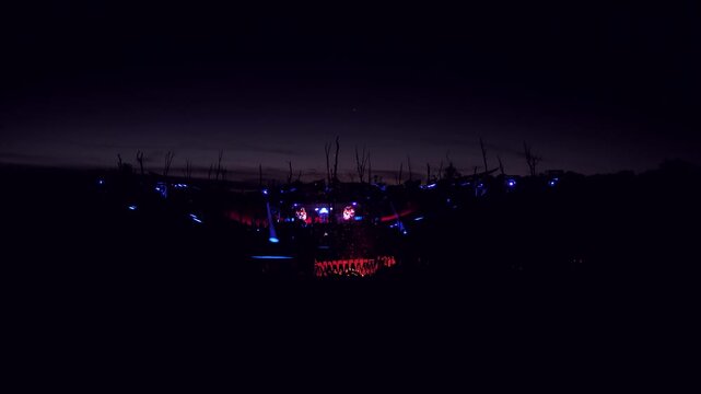Goa psy trance techno summer festival's main stage party with colorful lights design and fire at night