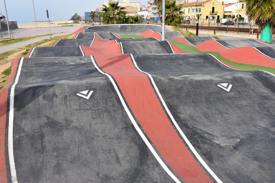 Outdoor red and black pump track, skatepark for biking