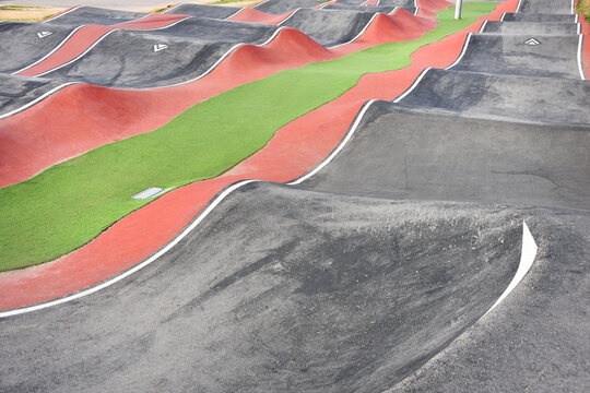 Outdoor red and black pump track, skatepark for biking