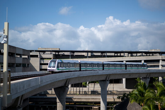 Honolulu Skyline Rail Train Curving Past Airport Parking Structure