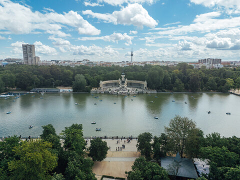 El Retiro park lake with boats and monument in Madrid