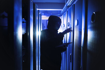 Criminal, person and hacking with tablet in server room for coding, cyberattack and data breach....