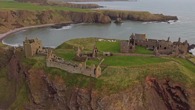 Impressive aerial perspective of dunnottar castle, a ruined medieval fortress located upon a rocky headland on the northeastern coast of scotland