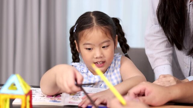 Mother and Daughter Learning Together at Home Table