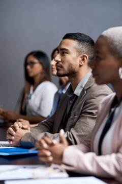 Serious, businessman and group in seminar for presentation, audience and wealth management training. Business people, team and listening to speech for financial growth, learn and meeting in workshop
