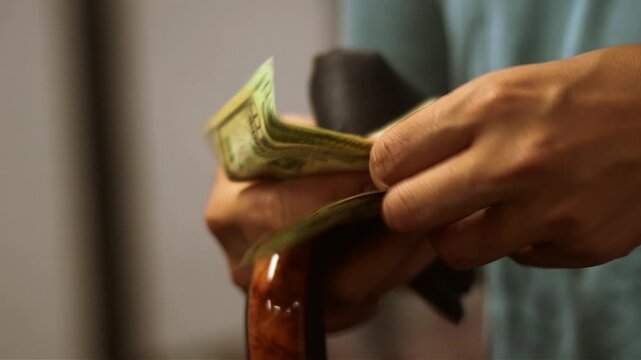 Taking money out of a wallet with your hand
