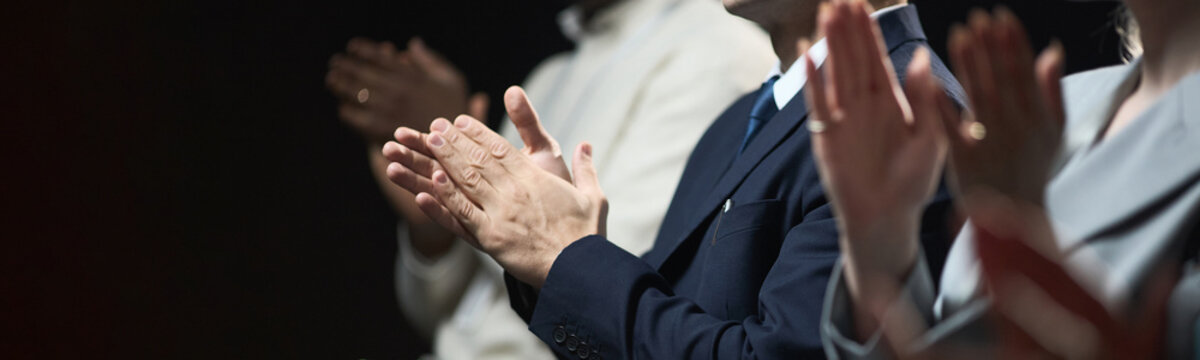 Business professionals clapping during corporate event, showing recognition, support, teamwork, and success. Useful for leadership, company culture, conference, and award marketing