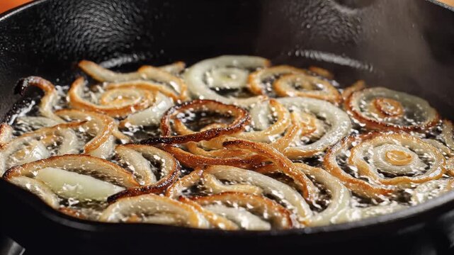 Closeup of Delicious Caramelized Onions Sizzling in a Cast Iron Skillet.