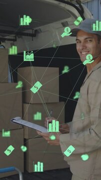 Vertical video: Driver checking log marking boxes for stock while green charts floating over him