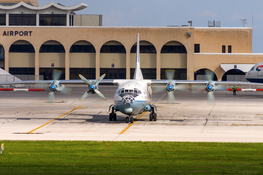 Luqa, Malta - December 24, 2005: Aerovis Airlines Antonov An-12AP (REG: UR-CCP), the "Russian Hercules", taxiing out of apron 9 for a take off from runway 32. 