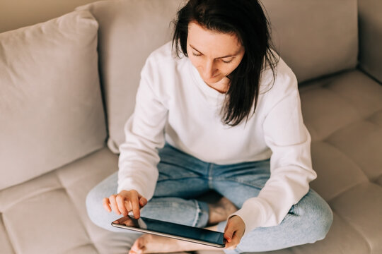Casual female person engaging with touchscreen device