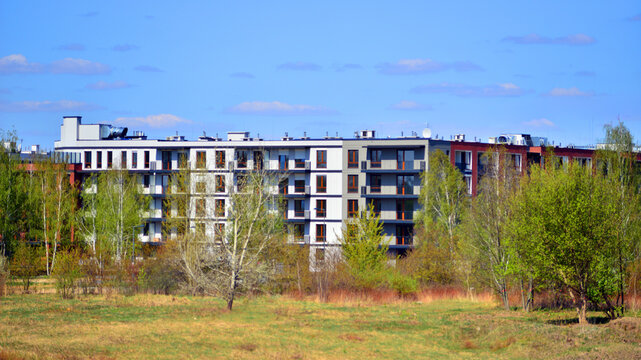 European residential architecture harmonizing with nature. Eco-friendly living in city with greens. Eco apartment building saving energy and fresh air concept. 