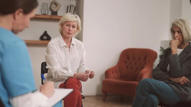 Frustrated woman speaking in group therapy meeting with psychologist in clinic. Consultation with professional psychoanalyst or physician endocrinologist, discussing problems of aging, mental health