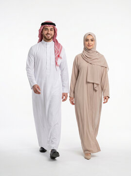 A young Saudi couple walking together on a clean white background, representing modern lifestyle, marriage, and cultural elegance.