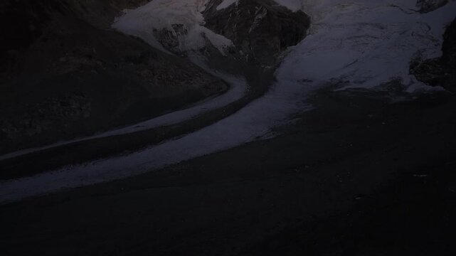 Aerial view of the Glacier de Cheilon during a summer evening in the Swiss Alps with a view of the ice, moraines and mountain peaks of the Arolla region such as the Mont Blanc de Cheilon